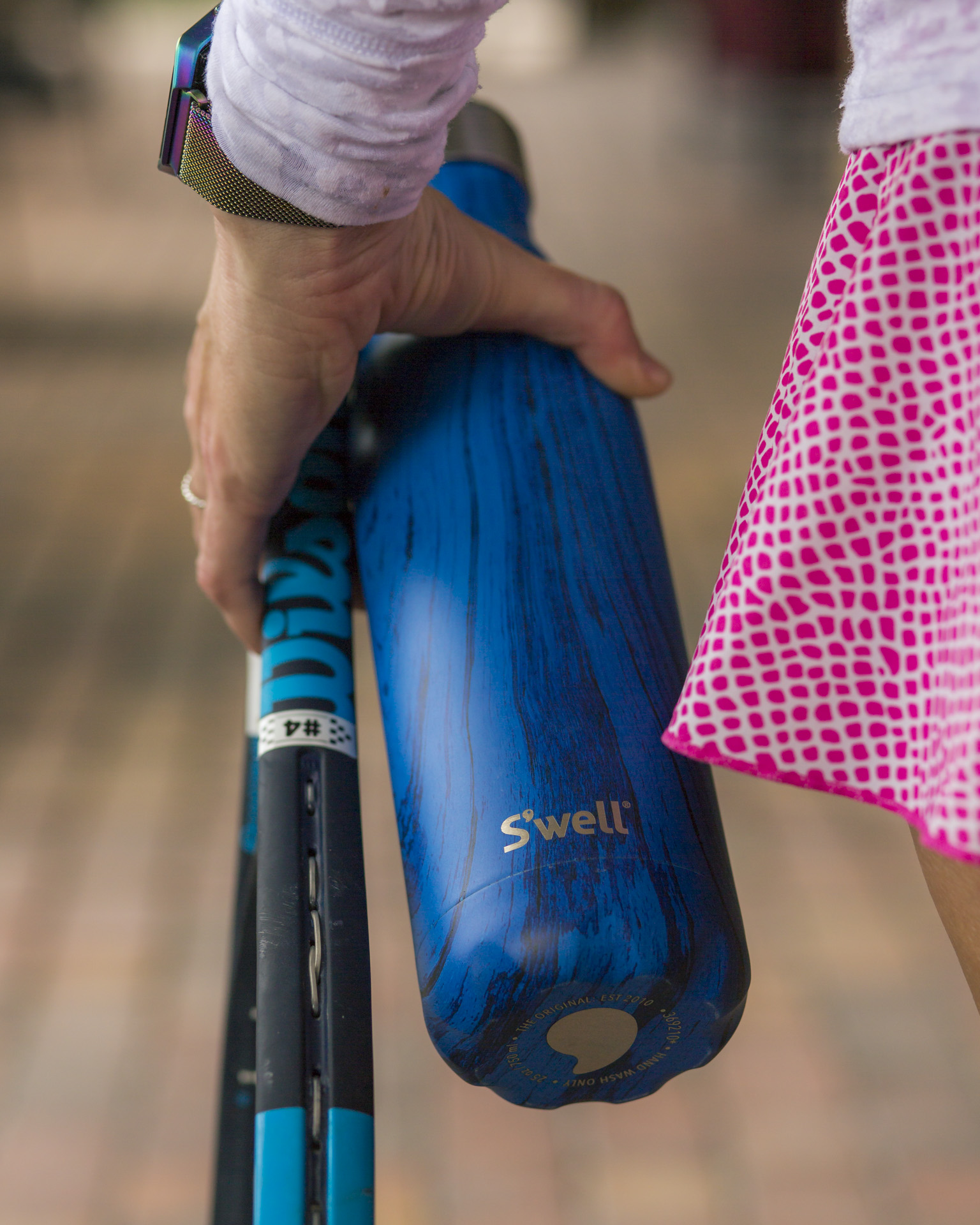 Woman holding tennis equipment.
